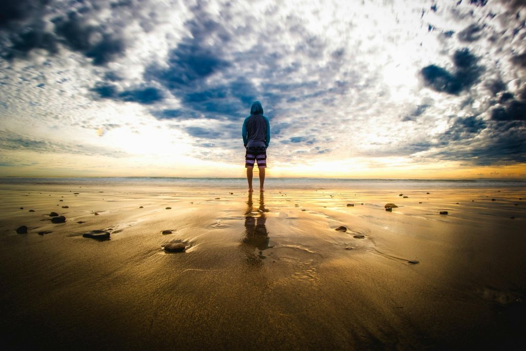 Person Standing on Sand